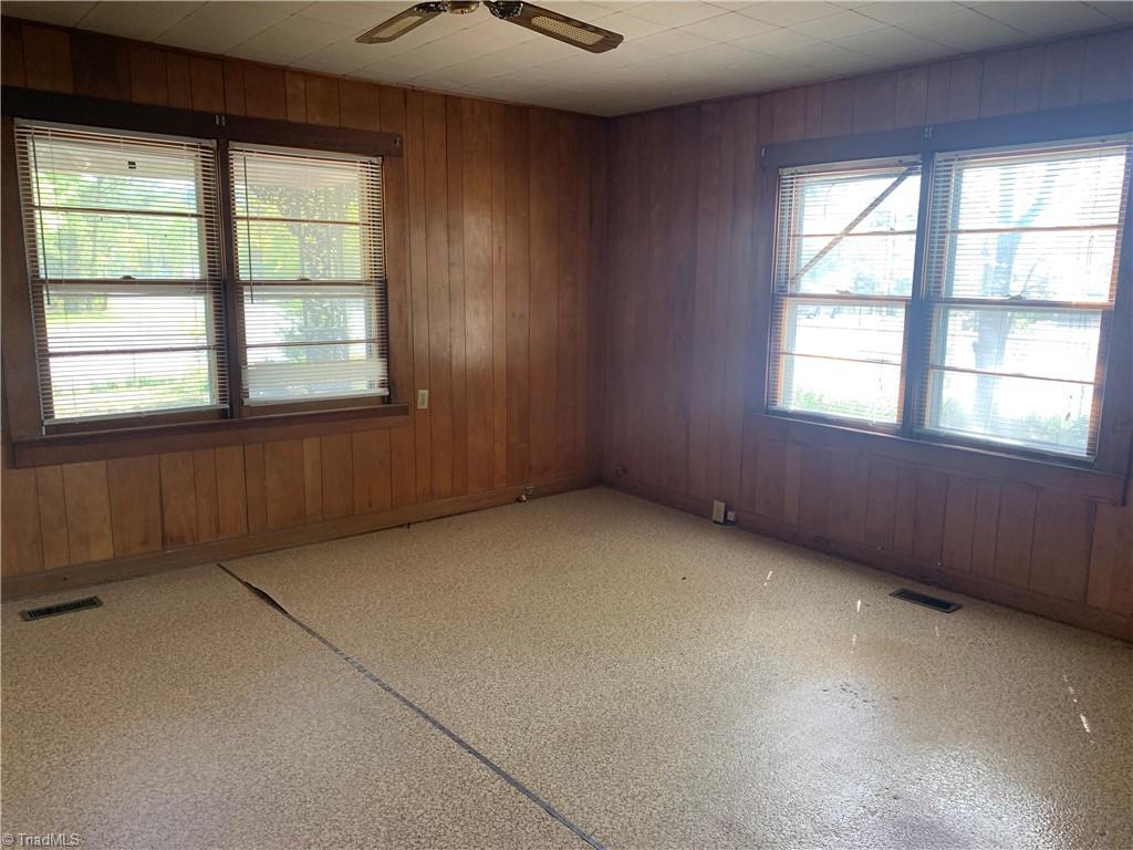 1684 Rose Ridge Road Jackson Springs, NC 27281 - Photo 32 of 47 Adorable 3 bed, 1 bath, fixer upper on a corner lot. House has lots of open space on 1.63 acres of completely fenced land. Multiple outbuildings stay. Mature trees and flowers. Large back deck with built in seating is perfect for entertaining or take a break on the rocking chair front porch. Close to camp grounds and golfing. Make it the home of your dreams.