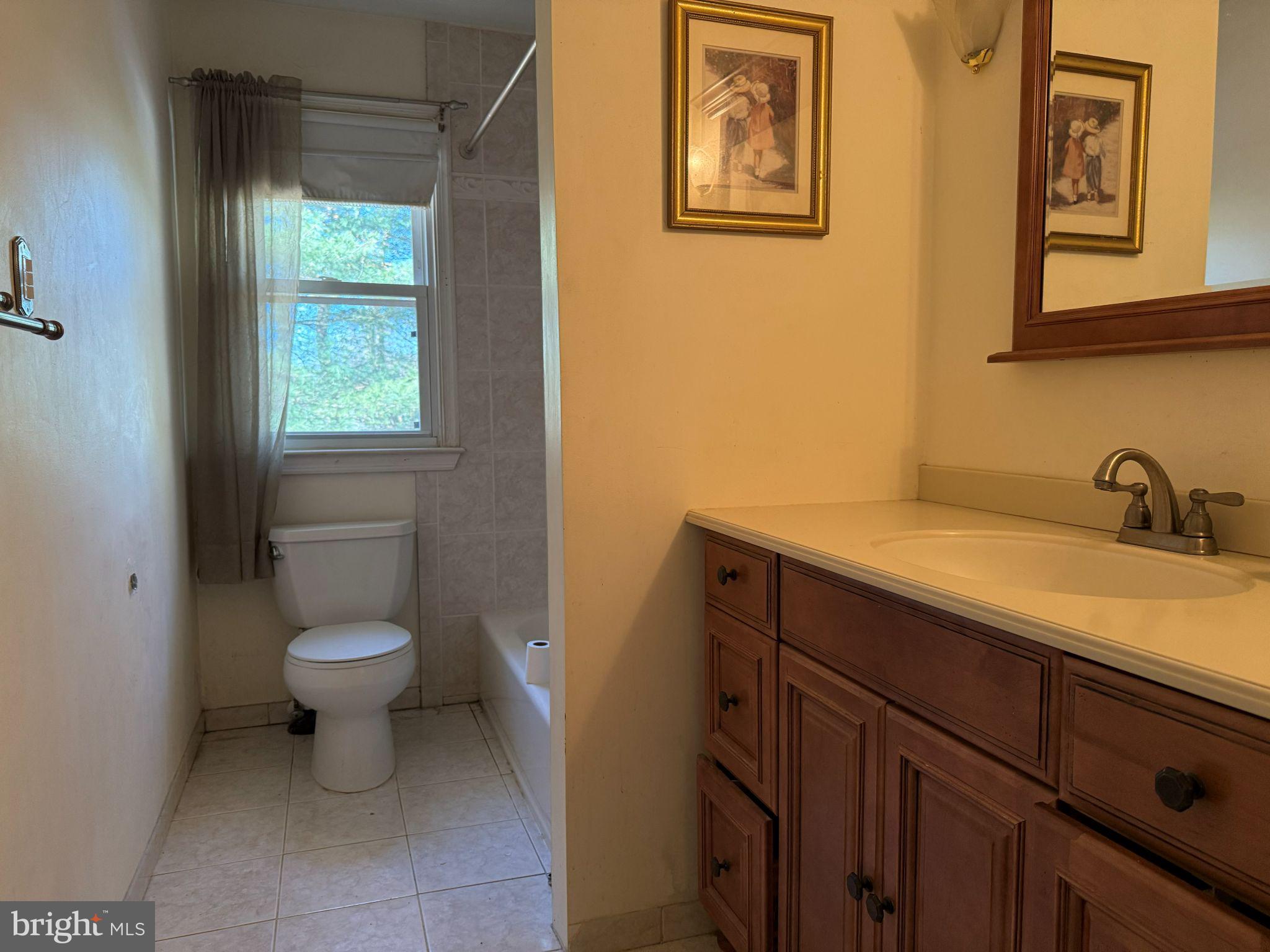 916 Edgemoor Road Cherry Hill, NJ 08034 - Photo 10 of 33 a bathroom with a toilet sink and mirror