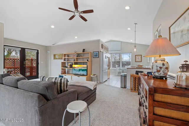 a living room with furniture a fireplace and a chandelier