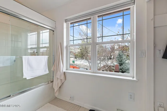 a bathroom with a bathtub and window