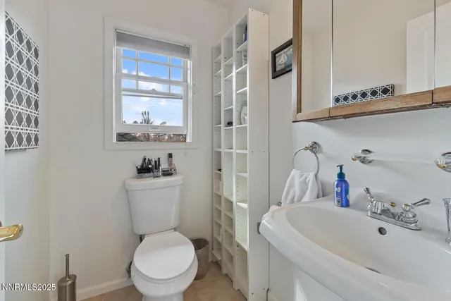 a white toilet sitting next to a bathroom sink
