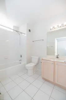 a view of a balcony with chairs and a potted plant