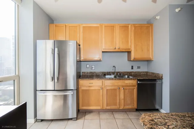 a kitchen with a refrigerator a stove a sink and a window
