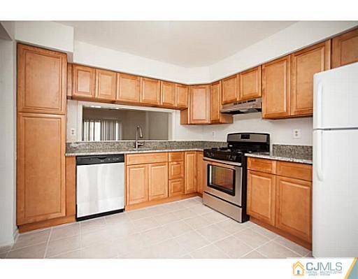 302 Timber Oaks Road Edison, NJ 08820 - Photo 2 of 16 a kitchen with stainless steel appliances granite countertop a refrigerator sink and cabinets