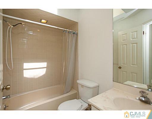 302 Timber Oaks Road Edison, NJ 08820 - Photo 15 of 16 a bathroom with a sink toilet and shower