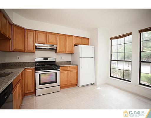 302 Timber Oaks Road Edison, NJ 08820 - Photo 3 of 16 a kitchen with a refrigerator and a stove top oven