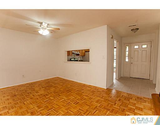302 Timber Oaks Road Edison, NJ 08820 - Photo 7 of 16 a view of empty room with wooden floor