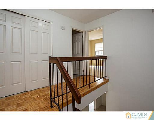 302 Timber Oaks Road Edison, NJ 08820 - Photo 10 of 16 a view of staircase with white walls and a window
