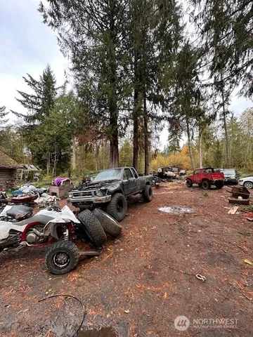 a view of a backyard with table and chairs and a fire pit