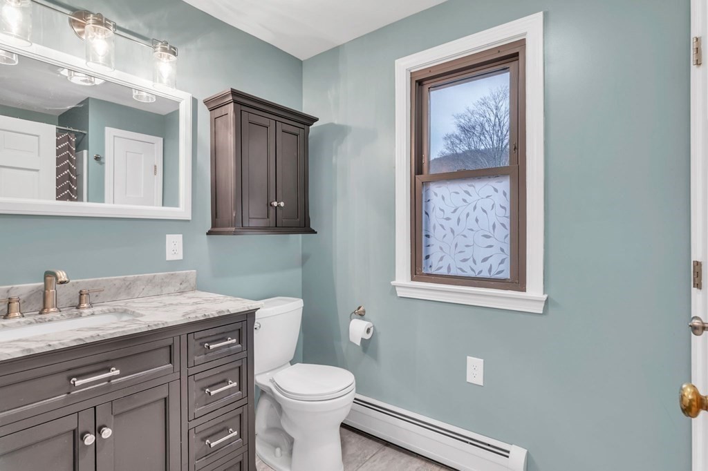 434 Chapin Road Hampden, MA 01036 - Photo 12 of 42 a bathroom with a toilet sink and mirror