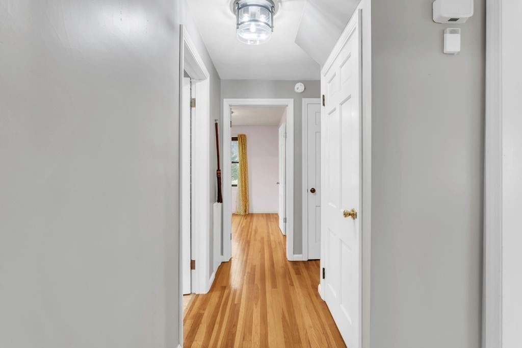 434 Chapin Road Hampden, MA 01036 - Photo 21 of 42 a view of a hallway with wooden floor and a bathroom