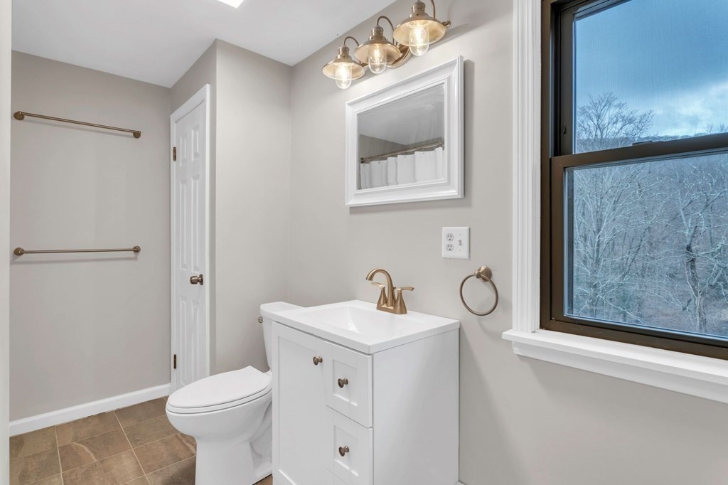 434 Chapin Road Hampden, MA 01036 - Photo 39 of 42 a bathroom with a toilet sink and mirror