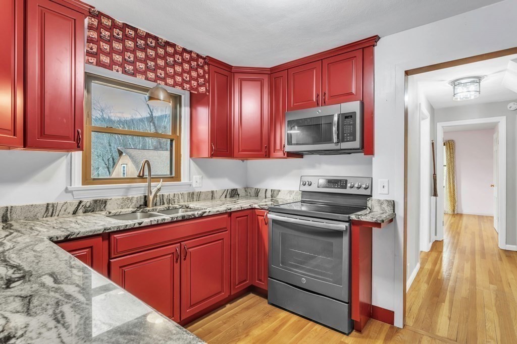 434 Chapin Road Hampden, MA 01036 - Photo 5 of 42 a kitchen with stainless steel appliances granite countertop a sink stove and cabinets