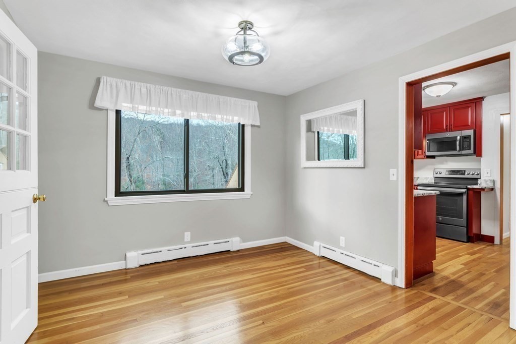 434 Chapin Road Hampden, MA 01036 - Photo 9 of 42 a view of a livingroom with wooden floor kitchen view and a window