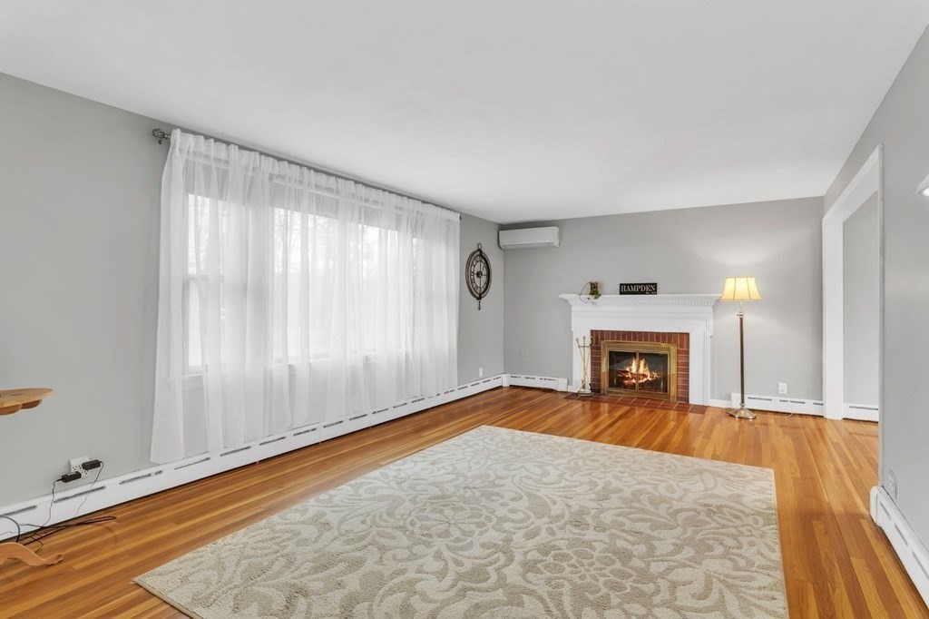 434 Chapin Road Hampden, MA 01036 - Photo 10 of 42 a view of an empty room with a fireplace and a window