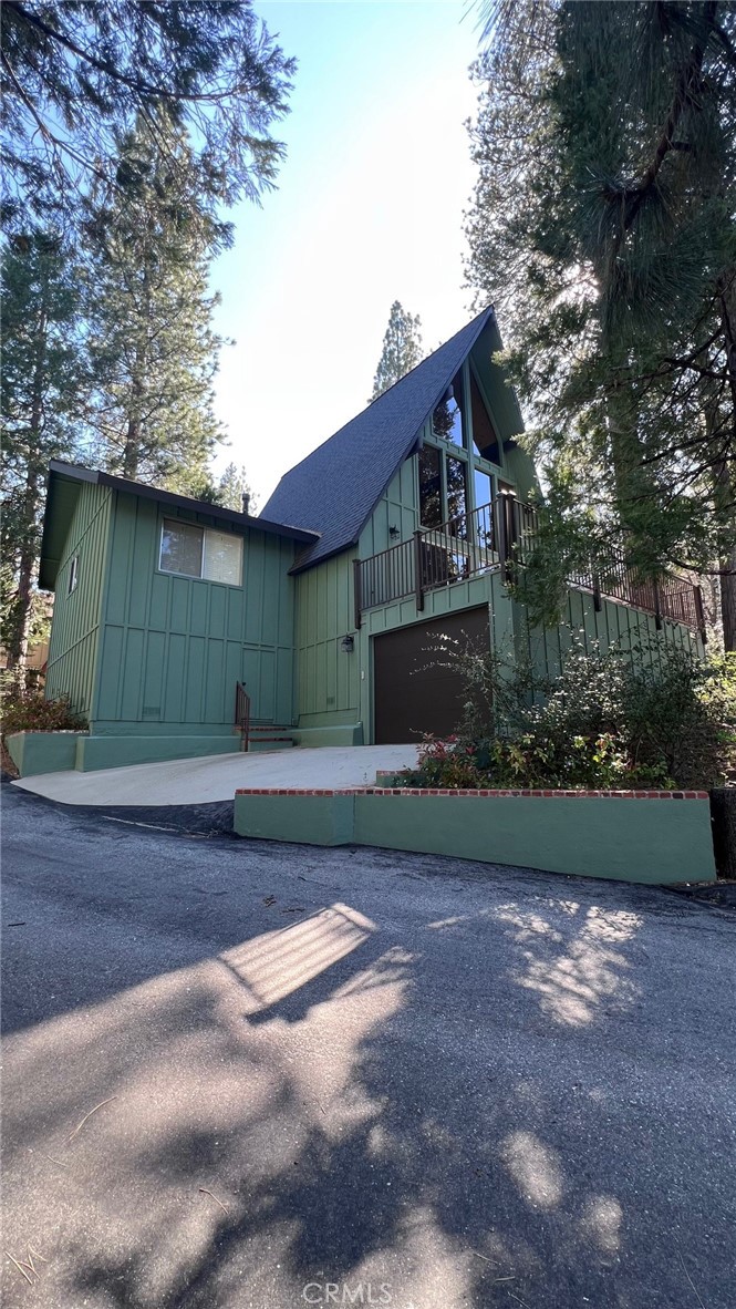 180 Grass Valley Road, Unit 42 Lake Arrowhead, CA 92352 - Photo 2 of 4 a front view of a house with a garden