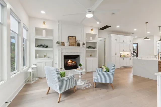 a living room with furniture a fireplace and a flat screen tv