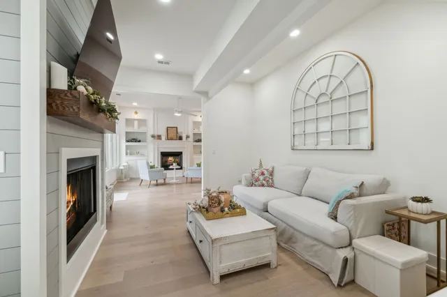 a large kitchen with stainless steel appliances lots of counter space and wooden floor