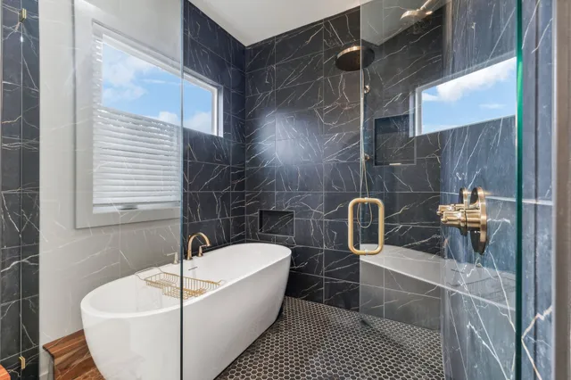 a bathroom with a bathtub and shower
