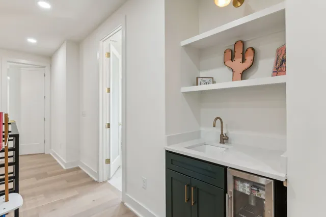 a bathroom with a sink vanity mirror and toilet