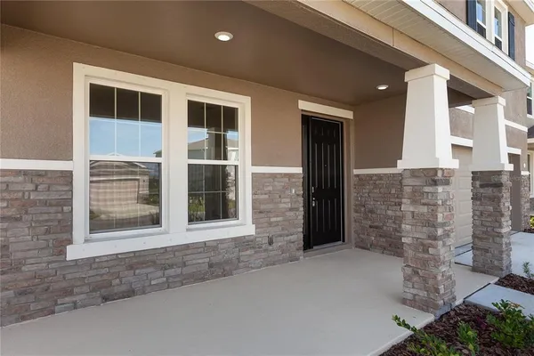 a view of a porch with a table and chairs