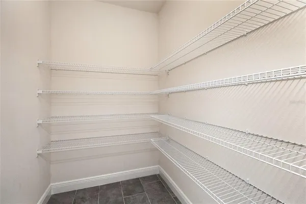 an empty room that has a wooden cupboard