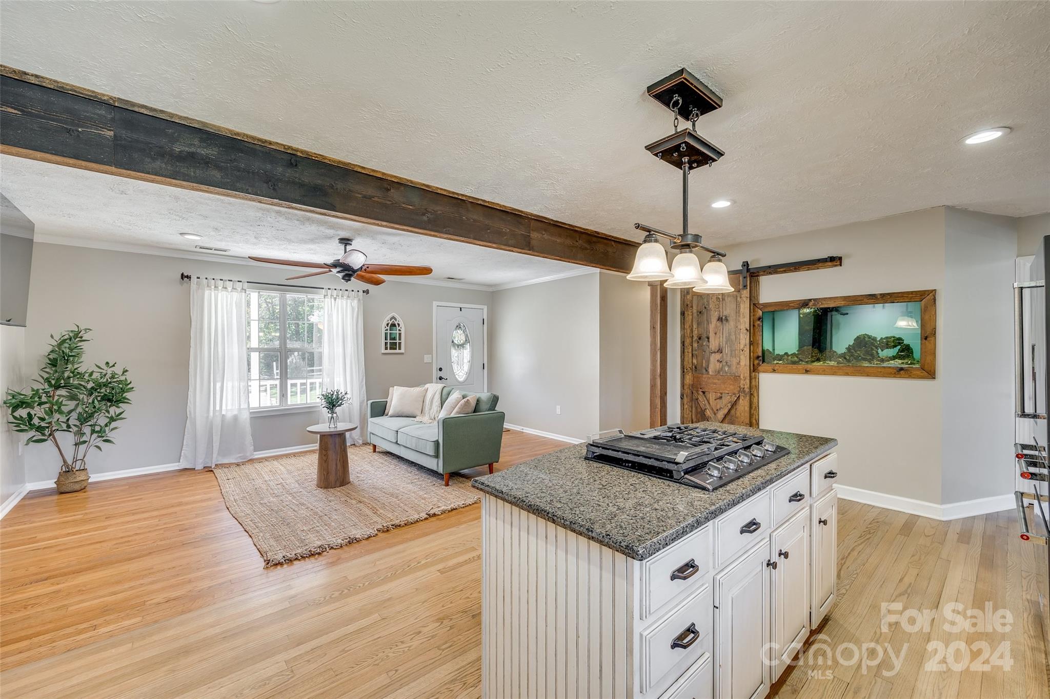 3110 Bush Road Clover, SC 29710 - Photo 7 of 48 a open kitchen with stainless steel appliances granite countertop a sink dishwasher and a dining table with wooden floor