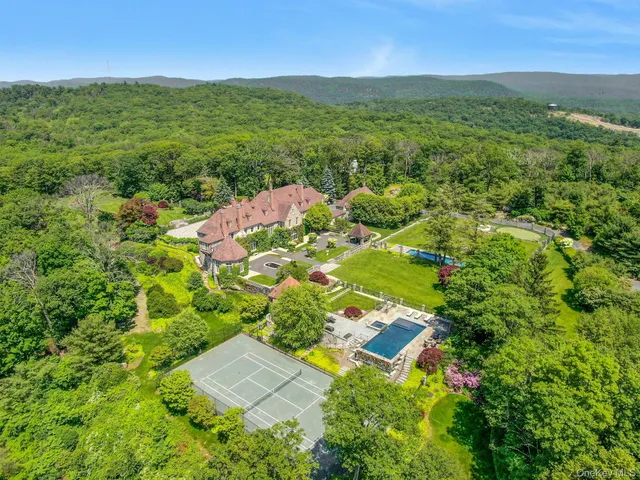 a bedroom with a bed a fireplace and a large window