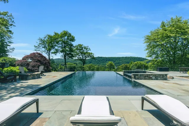 an aerial view of a house with garden space and trees