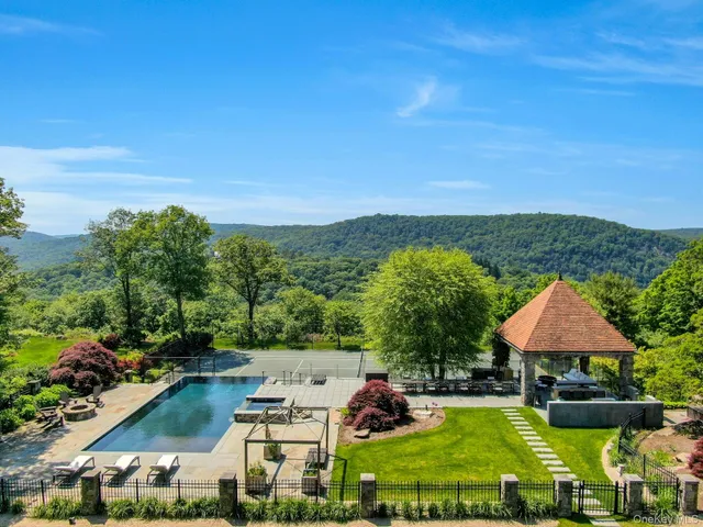 an aerial view of residential houses with outdoor space and swimming pool