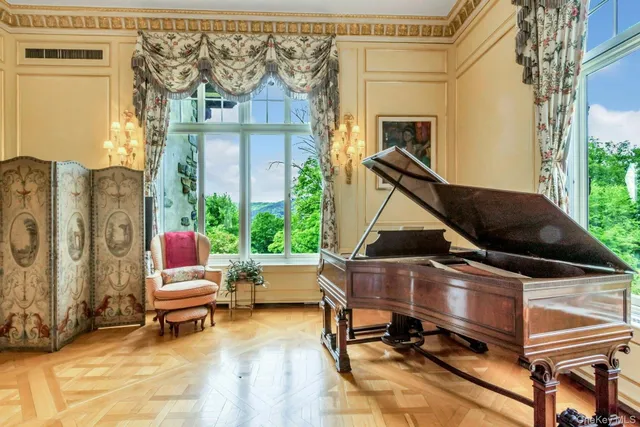 a living room with fireplace furniture and a large window