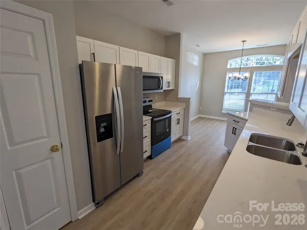 a kitchen with stainless steel appliances a refrigerator and a stove