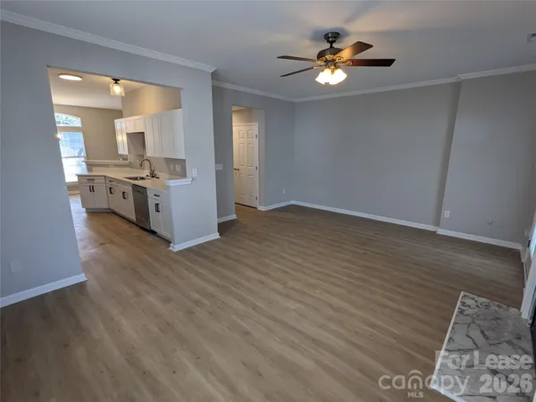 a view of living room with furniture and wooden floor