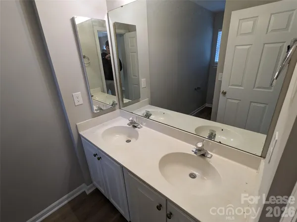 a bathroom with double vanity sink and mirror