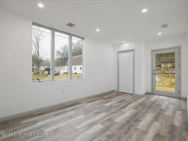 a bathroom with a window and a shower