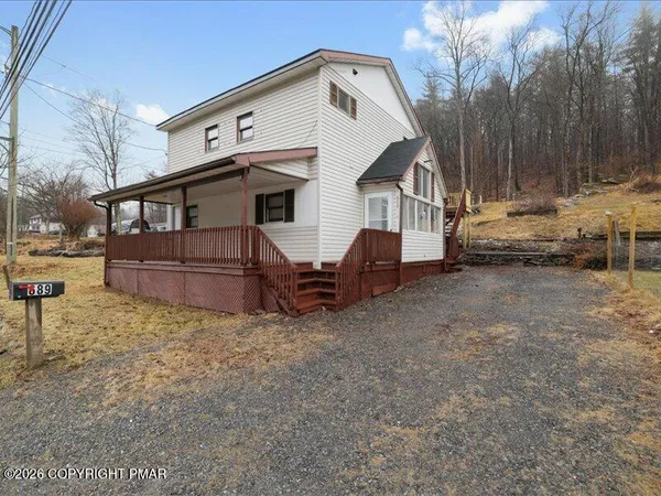 a view of a house with wooden fence