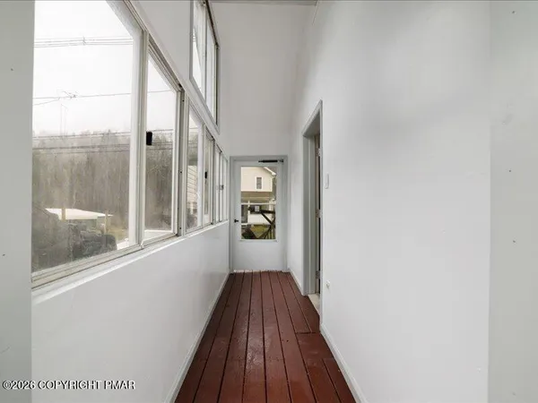a view of balcony with wooden floor and fence