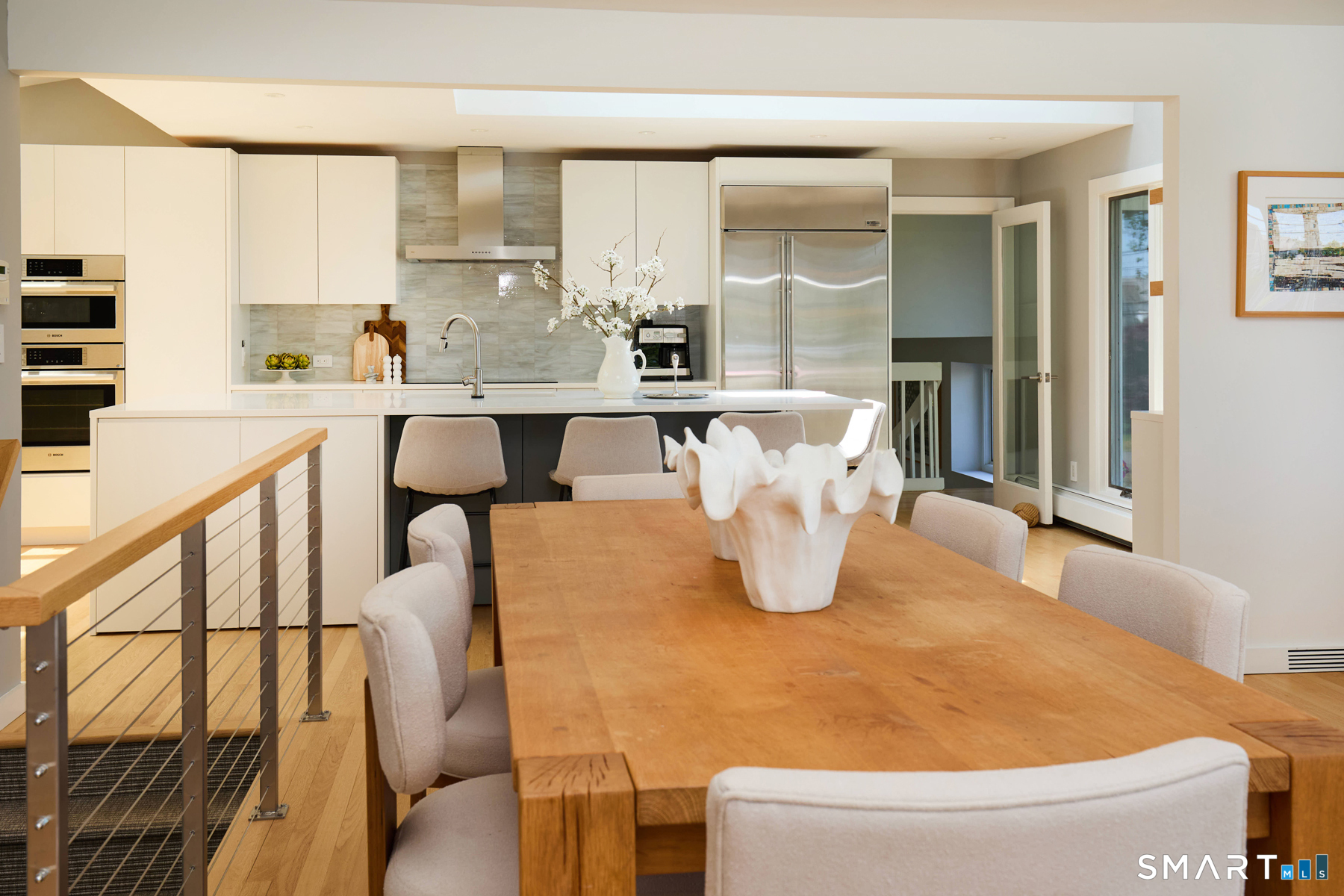 16 Harbor Road Westport, CT 06880 - Photo 6 of 36 a kitchen with a table chairs and a refrigerator