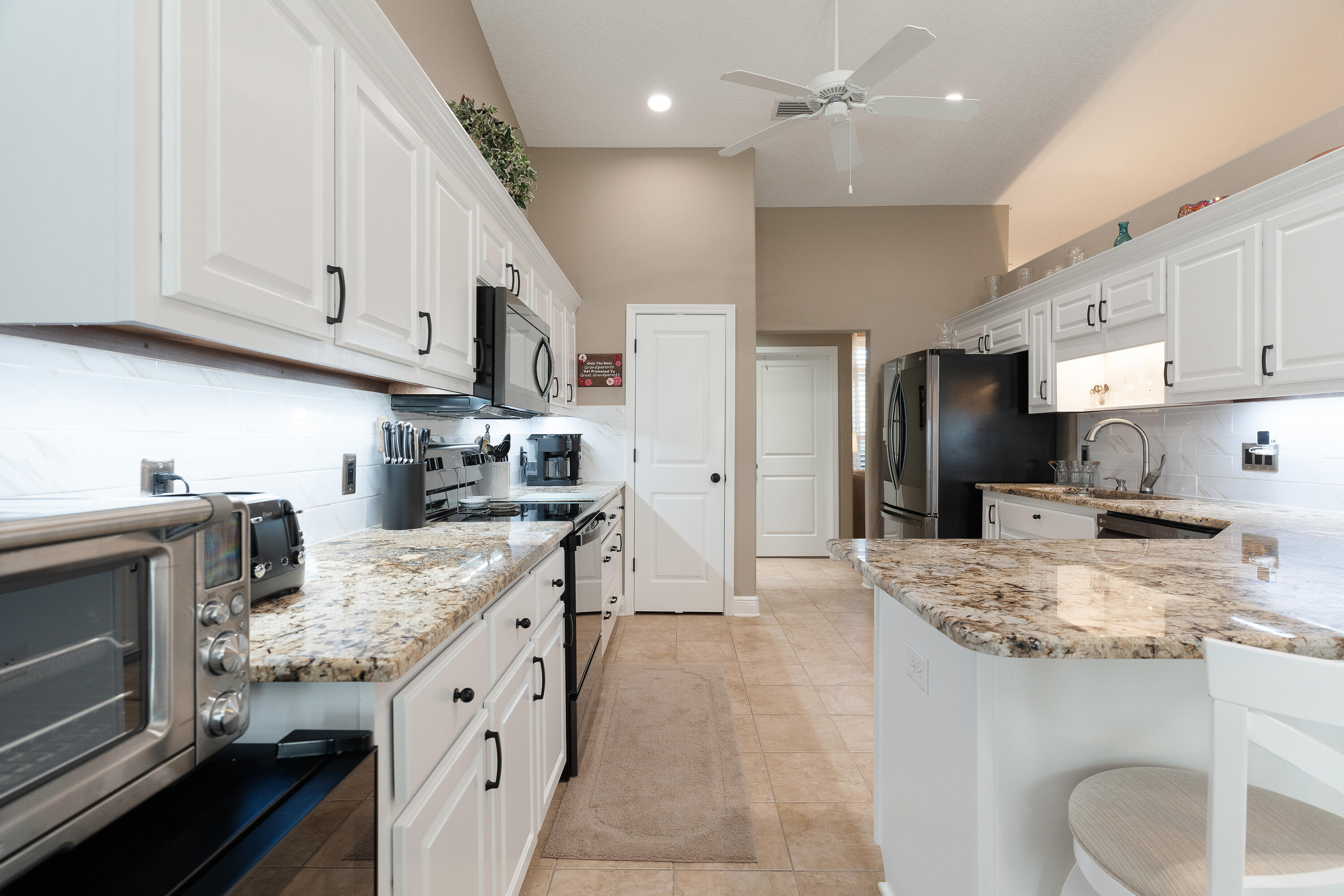 2300 Valley Place Navarre, FL 32566 - Photo 20 of 81 a kitchen with stainless steel appliances granite countertop a sink stove and refrigerator