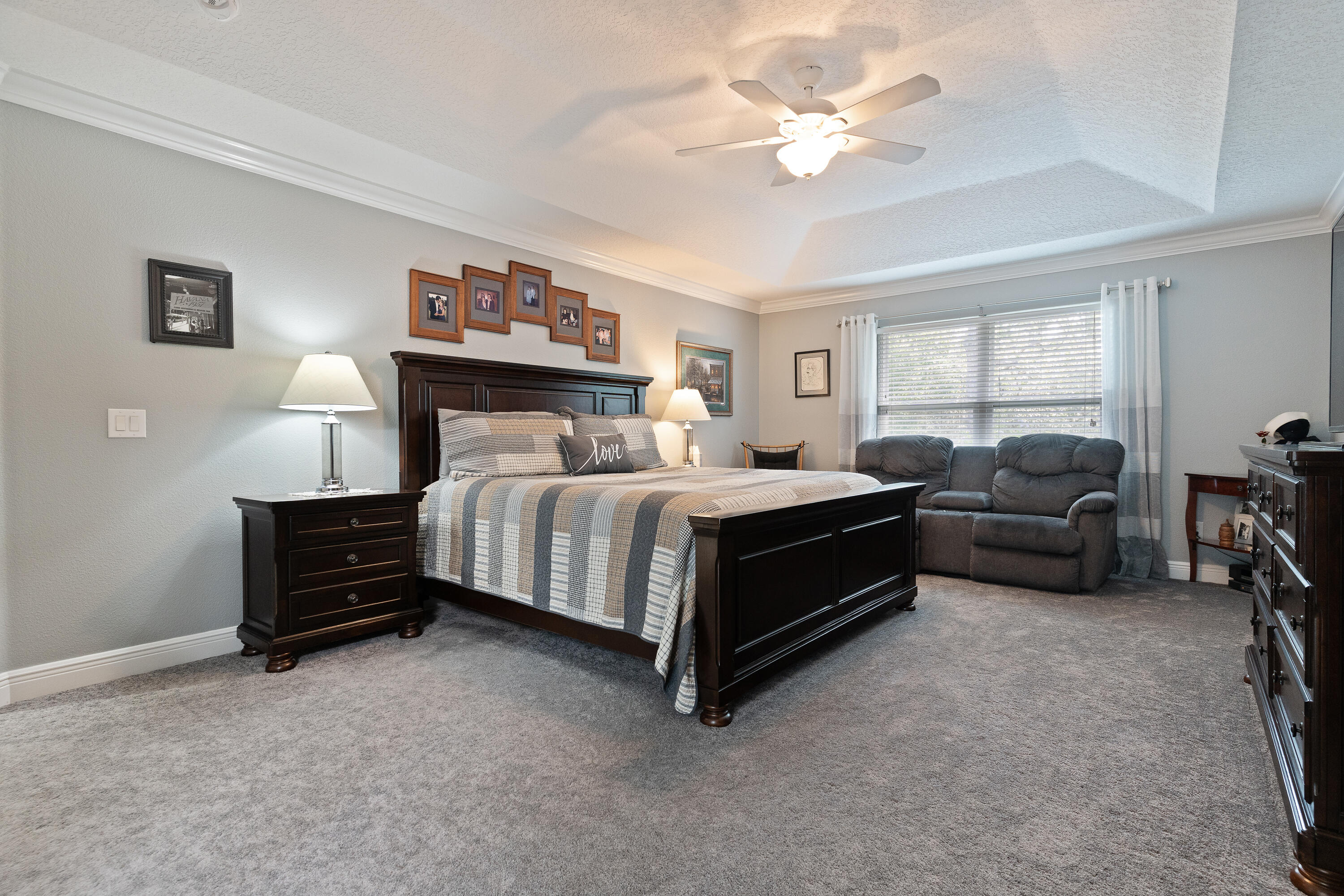 2300 Valley Place Navarre, FL 32566 - Photo 29 of 81 a bedroom with a bed and a chandelier