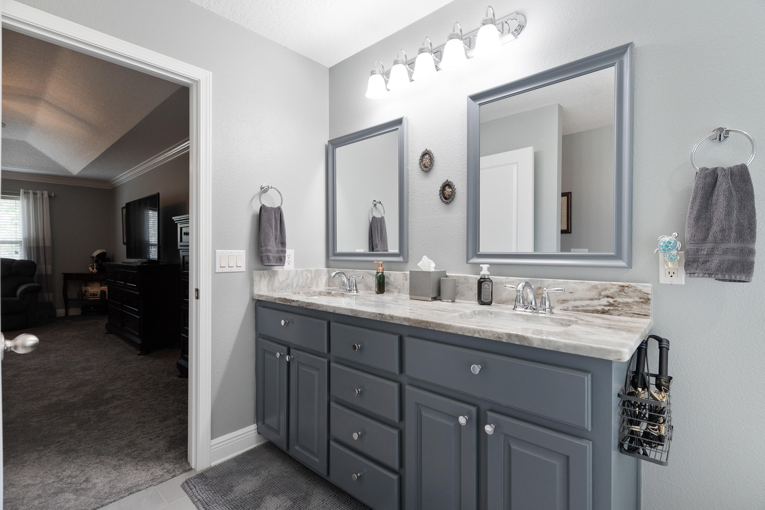 2300 Valley Place Navarre, FL 32566 - Photo 32 of 81 a en suite bathroom with a double vanity sink and a mirror