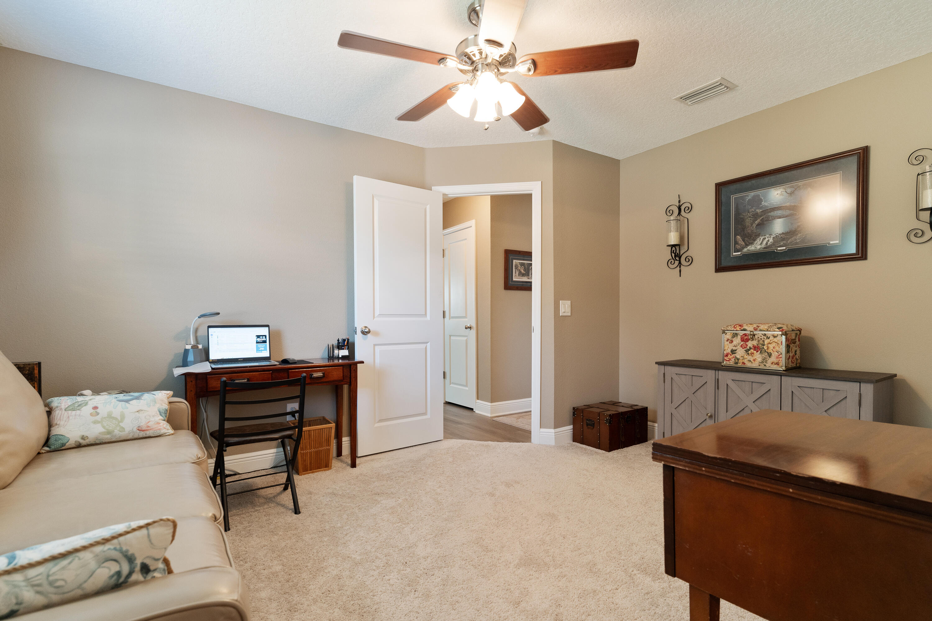 2300 Valley Place Navarre, FL 32566 - Photo 37 of 81 a bedroom with a bed and a chandelier