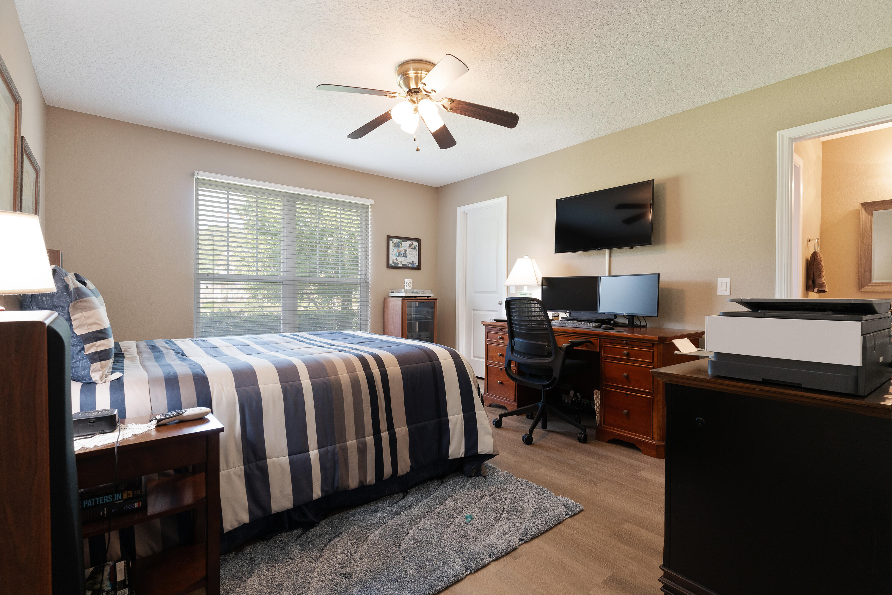 2300 Valley Place Navarre, FL 32566 - Photo 38 of 81 a bedroom with a bed and a flat screen tv