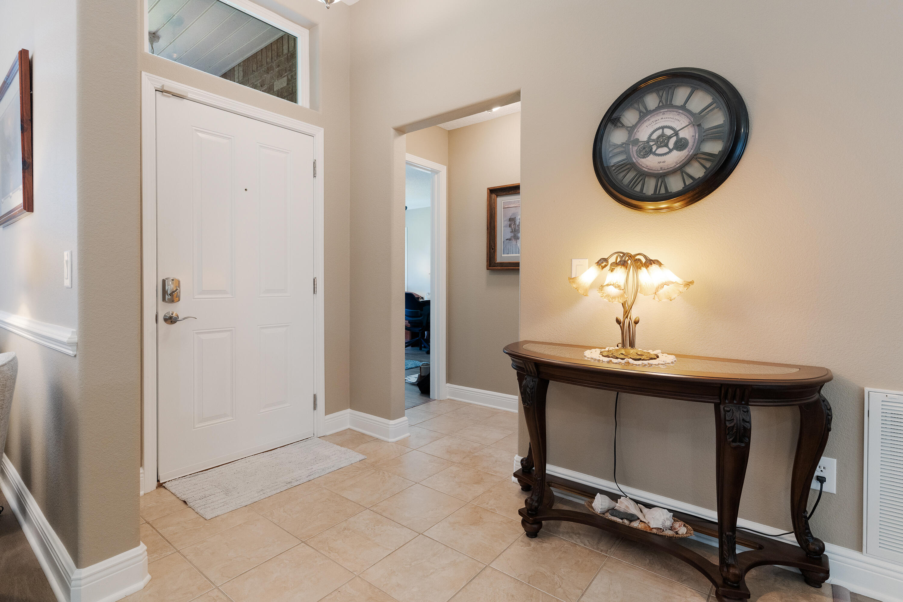2300 Valley Place Navarre, FL 32566 - Photo 5 of 81 a view of a hallway with a table and a mirror