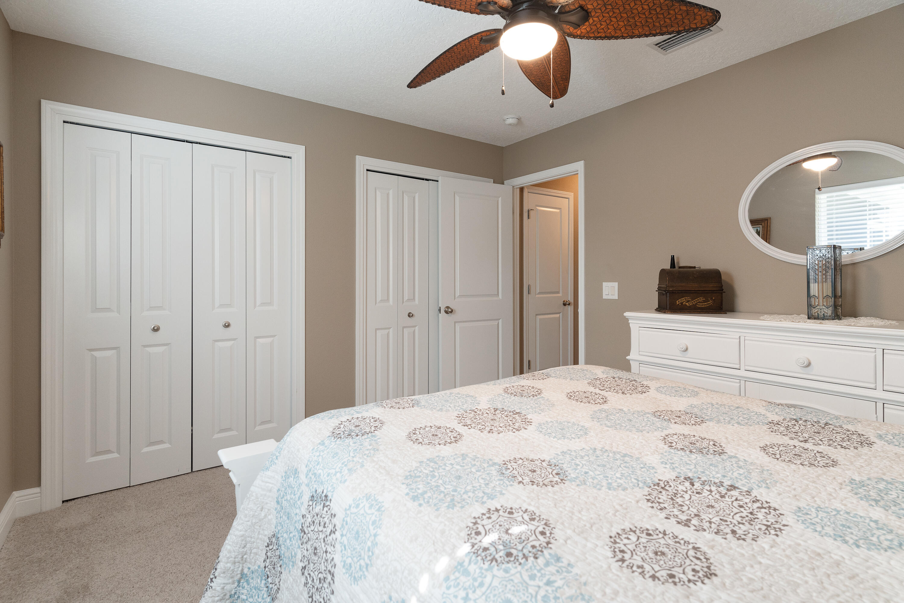 2300 Valley Place Navarre, FL 32566 - Photo 51 of 81 a bedroom with a large bed and a chandelier