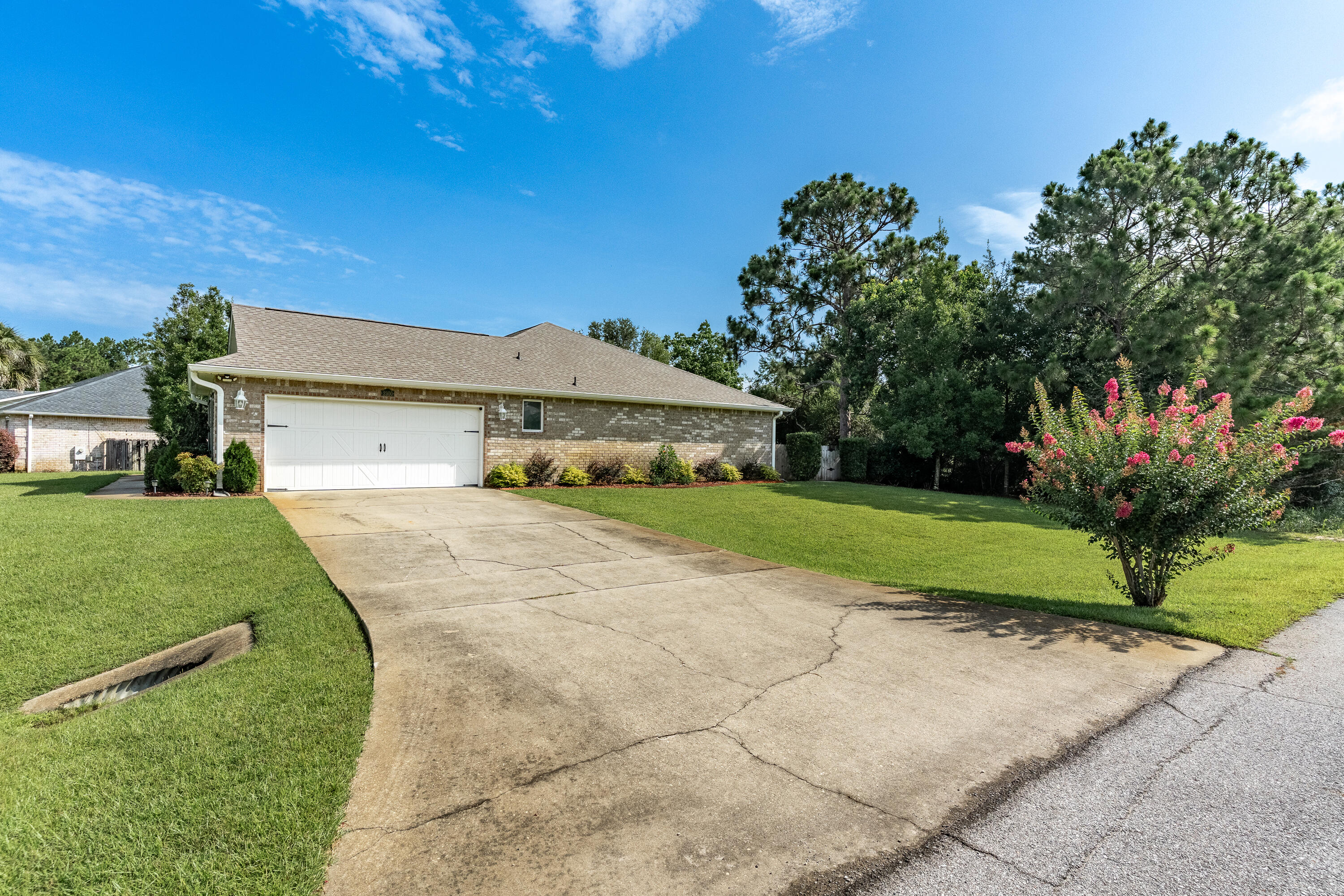 2300 Valley Place Navarre, FL 32566 - Photo 76 of 81 a front view of a house with a yard and garage