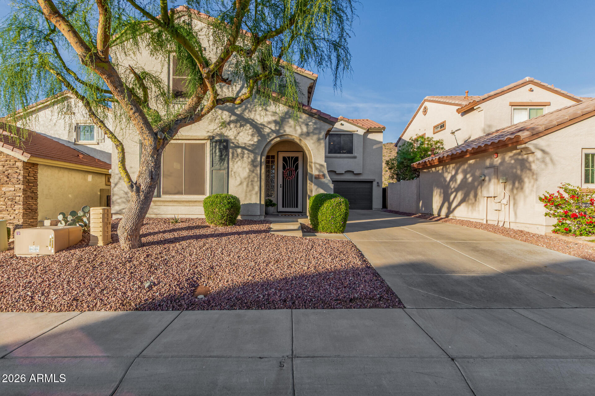 7316 West Montgomery Road Peoria, AZ 85383 - Photo 1 of 49 a front view of a house with a yard