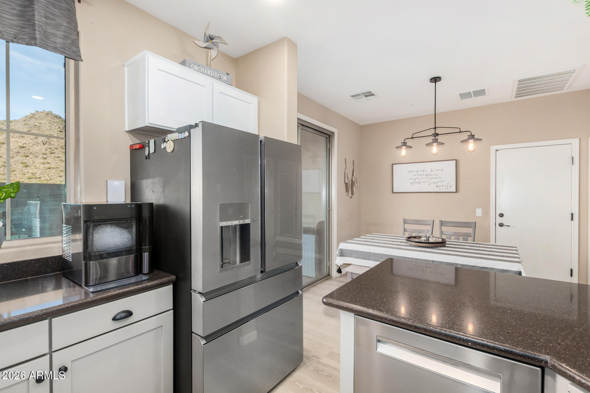 7316 West Montgomery Road Peoria, AZ 85383 - Photo 15 of 49 a kitchen with kitchen island a counter appliances and cabinets