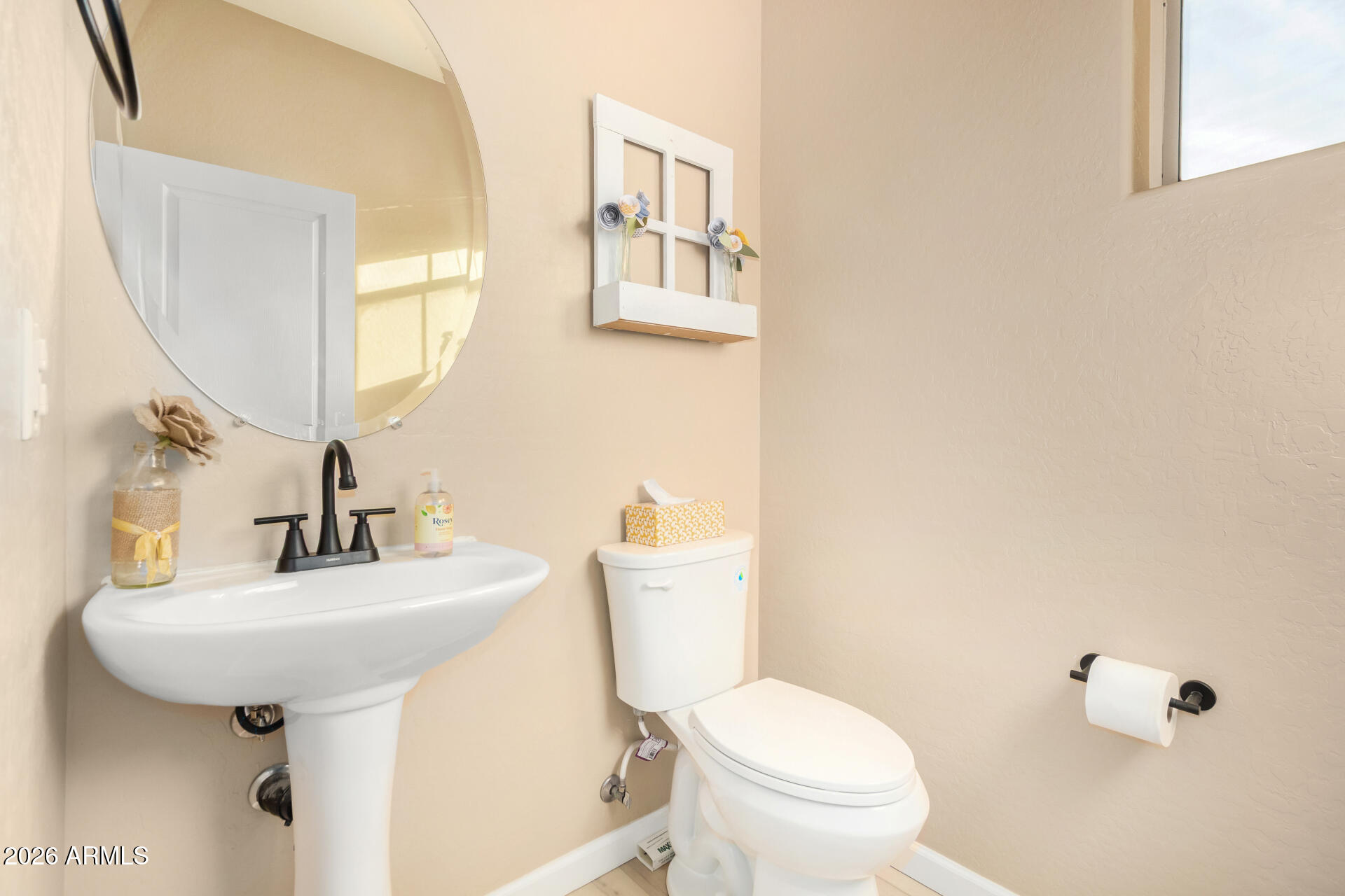7316 West Montgomery Road Peoria, AZ 85383 - Photo 17 of 49 a bathroom with a sink a mirror and a toilet