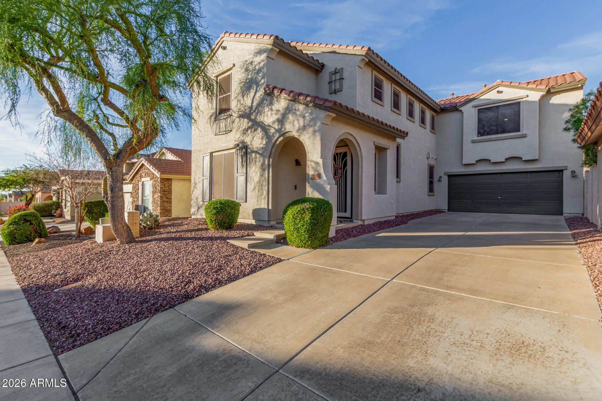 7316 West Montgomery Road Peoria, AZ 85383 - Photo 2 of 49 a front view of a house with garden